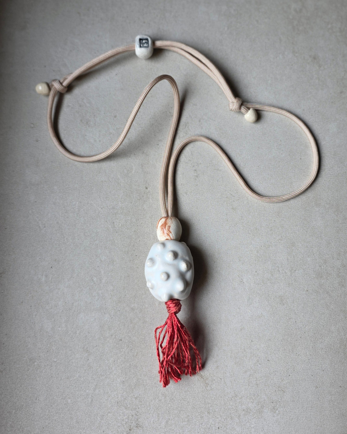 Collana Archeperla – Bianco – piano grigio, vista intera